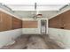 Spacious garage featuring a secure door, pegboard walls, and concrete floor at 900 S Palo Verde Dr, Apache Junction, AZ 85120