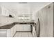 Efficient kitchen with stainless appliances, white cabinetry, black countertops, and natural lighting at 900 S Palo Verde Dr, Apache Junction, AZ 85120