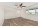 Bright living room shows wood look floors, modern ceiling fan, neutral paint and natural lighting at 900 S Palo Verde Dr, Apache Junction, AZ 85120
