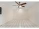 Neutral living room featuring white walls, tile floors, and a ceiling fan for comfort at 900 S Palo Verde Dr, Apache Junction, AZ 85120