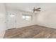 Bright living room features wood look flooring, a modern ceiling fan, and neutral paint at 900 S Palo Verde Dr, Apache Junction, AZ 85120