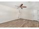 Bright living room with wood look flooring, ceiling fan, neutral paint and easy access to other rooms at 900 S Palo Verde Dr, Apache Junction, AZ 85120