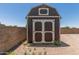 Exterior of the shed featuring a dual-door design with a painted exterior and a small window at 900 S Palo Verde Dr, Apache Junction, AZ 85120