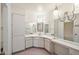 Bright bathroom featuring spacious vanity with ample counter space, large mirror and storage at 9613 W Shasta Dr, Sun City, AZ 85351