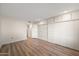 Bedroom featuring wood floors, closets, and access to the main living space at 9613 W Shasta Dr, Sun City, AZ 85351