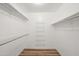 Walk-in closet with wooden floors, white walls, and shelving for storage at 9613 W Shasta Dr, Sun City, AZ 85351