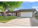 Charming brick home with a two-car garage and well-maintained landscaping in front at 9613 W Shasta Dr, Sun City, AZ 85351