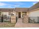 Charming home exterior showcasing a brick entrance with black iron gate, tiled walkway, and inviting front door at 9613 W Shasta Dr, Sun City, AZ 85351