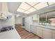 Bright kitchen with white appliances and cabinets, complemented by modern flooring at 9613 W Shasta Dr, Sun City, AZ 85351