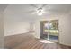 Spacious living room with modern flooring, fan, and natural light from sliding glass doors at 9613 W Shasta Dr, Sun City, AZ 85351