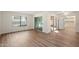Bright living room with modern flooring, large windows and access to the kitchen at 9613 W Shasta Dr, Sun City, AZ 85351