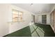 Sunroom featuring sliding glass doors, white walls, and green indoor-outdoor carpet at 9613 W Shasta Dr, Sun City, AZ 85351