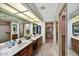 Bright bathroom with double sinks, large mirrors, and a separate shower room at 9645 W Kimberly Way, Peoria, AZ 85382