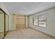 Bright bedroom features built-in shelving, large window, and sliding door closet at 9645 W Kimberly Way, Peoria, AZ 85382