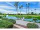 Scenic golf course view with pond, fountain, bridge and palm trees at 9645 W Kimberly Way, Peoria, AZ 85382