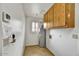 Functional laundry room with tiled floor, water heater, and wall cabinet at 9645 W Kimberly Way, Peoria, AZ 85382