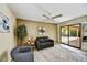 Inviting living area with neutral tones, ceiling fan, and sliding glass doors to outdoor space at 9645 W Kimberly Way, Peoria, AZ 85382