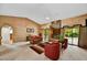 Bright living room with a fireplace, neutral carpet, and sliding glass doors to the outdoors at 9645 W Kimberly Way, Peoria, AZ 85382