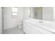 Bright bathroom featuring a large mirror and spacious vanity with storage at 9851 W Agora Ln, Tolleson, AZ 85353