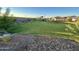Community park with playground area, lush green grass, and stream at 9851 W Agora Ln, Tolleson, AZ 85353