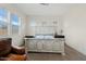 Bright bedroom featuring a distressed white wood bed frame and multiple windows at 10220 E Thatcher Ave, Mesa, AZ 85212