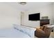 Bedroom features a distressed white wood bed frame and wall mounted TV at 10220 E Thatcher Ave, Mesa, AZ 85212