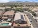 Aerial view featuring a pool, solar panels, and desert landscaping in a well-maintained neighborhood at 10442 W Toronto Way, Tolleson, AZ 85353
