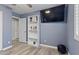 Cozy bedroom with a ceiling fan, laminate wood floors and a TV at 10442 W Toronto Way, Tolleson, AZ 85353