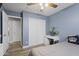 This bedroom features a desk, closet, ceiling fan and wood-style flooring at 10442 W Toronto Way, Tolleson, AZ 85353