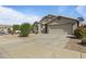 Well-maintained single-story home with two car garage and desert landscaping at 10442 W Toronto Way, Tolleson, AZ 85353