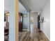 Inviting hallway featuring hardwood floors and neutral paint, leading to other rooms at 10442 W Toronto Way, Tolleson, AZ 85353