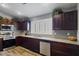 Spacious kitchen with dark wood cabinetry, stainless steel appliances, and shuttered windows at 10442 W Toronto Way, Tolleson, AZ 85353