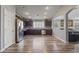 Bright open kitchen with dark cabinets, stainless steel appliances, and an eat-in area at 10442 W Toronto Way, Tolleson, AZ 85353