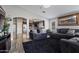 Open-concept living area with views into the kitchen, dark wood floors, and neutral walls at 10442 W Toronto Way, Tolleson, AZ 85353