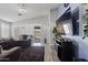 Well-lit living room with sliding doors, sleek entertainment center, and comfortable seating at 10442 W Toronto Way, Tolleson, AZ 85353