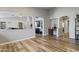 Inviting living area with hardwood floors, neutral walls, and archways leading to other spaces at 10442 W Toronto Way, Tolleson, AZ 85353