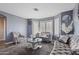 Elegant living room with plush seating, a stylish coffee table and natural light at 10442 W Toronto Way, Tolleson, AZ 85353