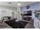 Cozy living room with plush seating, modern lighting, and an entertainment center at 10442 W Toronto Way, Tolleson, AZ 85353