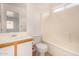 Bright bathroom with a single sink vanity, toilet, and shower-tub combo at 12132 W Dahlia Dr, El Mirage, AZ 85335