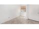 Bright bedroom with wood-look tile flooring, fresh white paint and a large window at 12132 W Dahlia Dr, El Mirage, AZ 85335