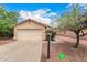 Charming single-story home with a well-maintained front yard and attached two-car garage at 12132 W Dahlia Dr, El Mirage, AZ 85335