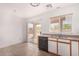 Functional kitchen featuring a window, sliding glass doors, and classic laminate countertops and cabinets at 12132 W Dahlia Dr, El Mirage, AZ 85335