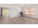 Inviting living room with sliding glass doors, neutral walls, and stylish wood-look tile flooring at 12132 W Dahlia Dr, El Mirage, AZ 85335