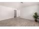 Bright living room featuring wood-look tile flooring, neutral walls, and an arched doorway at 12132 W Dahlia Dr, El Mirage, AZ 85335