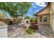 Inviting backyard with stone fireplace, patio, lush landscaping, and mature trees offering a private outdoor retreat at 122 W Cottage Ln, Tempe, AZ 85282