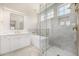 Luxurious bathroom with marble shower, soaking tub, dual vanities, and elegant gold fixtures at 122 W Cottage Ln, Tempe, AZ 85282