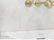 Close-up of a modern faucet over a sleek bathtub with a marble backdrop and gold fixtures at 122 W Cottage Ln, Tempe, AZ 85282