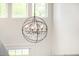 Wrought iron and crystal chandelier in entry above stairwell with window at 122 W Cottage Ln, Tempe, AZ 85282