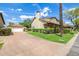 Beautiful home featuring a detached garage, a well-manicured lawn, and a spacious driveway at 122 W Cottage Ln, Tempe, AZ 85282