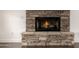 Stone fireplace with a black metal firebox and a roaring fire at 122 W Cottage Ln, Tempe, AZ 85282